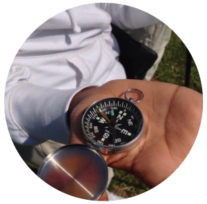 Student in a science class holding a compass.